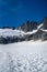 vertical wide shot of jagged mountain landscape covered in snow on top of glacier
