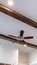 Vertical Wood beams and recessed bulbs with ceiling fan and lights at the center