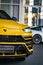 Vertical of Yellow Lamborghini Urus front view with headlights on