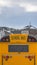 Vertical Yellow school bus with rectangular window and several signal lights at the rear