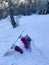 VERTICAL: Young female snowboarder crashes face first into the fresh powder snow