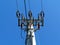 Vertically dropping electrical cables concrete pole. clear blue sky