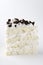 Verticl image.Piece of delicious biscuit cake with cookie crumbs on the white background