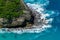 Vertiginous, swirling foamy water waves at the ocean photographed from above cliff.