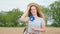 Very attractive with large smile young woman looking straight to the camera and enjoying the time in the middle of wheat