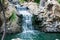 Very beautiful artificial waterfalls with living water and growing moss. Water flows from above, splashes and drops around