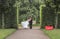 Very beautiful bride with groom hugging and dancing in green park, real wedding couple together forever happy smiling