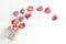 Very beautiful composition on a marble surface. pink buds and a glass vase with a gold detail. dry roses on a light background.