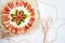 Very beautiful summer cheesecake decorated with strawberries - stands on a white wooden table