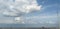 Very beautiful white clouds and blue-sky and wire poles and solar panel lines on the ground.