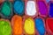 A very bright multicolored paint powders in bags and a small spoon. paints for the holiday of Holi