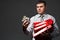 Very busy businessman closeup portrait, posing with red folders, overworking concept, dark wall background