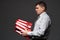 Very busy businessman closeup portrait, posing with red folders, overworking concept, dark wall background