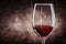 Very close up wineglass with red wine on wood background