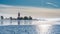 Very close view of red white lighthouse in middle of frozen, snowed island at cold Baltic Sea, partly open water, thin ice