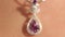 Very closeup of silver pendant with a magenta diamond on the beautiful woman`s neck.Jewellery.Shallow depth of field