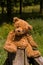 Very cute teddybear sitting on the fence