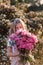 Very cute teenage girl with flowers in a red sundress posing