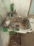 Very dirty old sink and faucet on the street in Central Asia