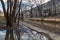 Very dirty pedestrian area with puddles and footprints. Background . The soggy soil of a village road