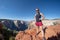 Very fit woman stands on top of Observation Point in Zion National Park