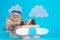 Very funny Scottish or British wearing a pilot`s cap and sitting in a plane on the background of clouds in a plane, like a boss