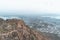 Very hazy, polluted aerial cityscape view from the Monsoon Palace of Udaipur, India