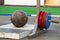 Very heavy stone sphere for power sports and set pancakes for barbell