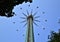 A very high carousel, at the Prater the amusement park in Vienna, people sitting on the seats rotate quickly and form rays, going