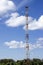 Very high cell tower on a background of blue sky