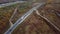 Very high up drone shot of red truck with trailer driving an interstate highway