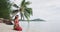 Very iconic video of woman wearing traditional pareo and Bikini relaxing sitting down on a paradise beach on Bora Bora