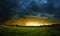 Very intense storm scene with rain on the left side and sunlight at the horizon