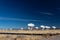 Very Large Array bright white radio antenna dishes against a deep blue sky, New Mexico desert in winter