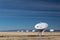 Very Large Array of radio astronomy observatory dishes in winter, science and technology