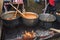 Very large cauldron cooking food during campfire. Cooking in a pot on the fire. Camping concept