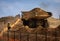 A very large haul dump truck at a construction site with a worker nearby