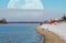 Very large Supermoon rises above the horizon. Beach on the bank of the river on a sunny winter day. Photo collage