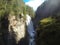 a very large waterfall flowing through a big canyon explorers through the canyon