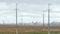 Very long wires and large power transmission poles. Power line in the countryside on the outskirts. Old electric pillar