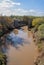 Very muddy river and the base of the destroyed old bridge