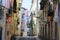 A very narrow street in the city of Lisbon, the capital of Portugal
