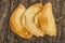 Very nice empanadas on wooden surface, perfect golden color and rustic elegant presentation, as seen from above