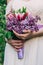 Very nice young woman holding big and beautiful colourful flower wedding bouquet