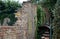 Very old brick wall partly demolished and overgrown with ivy. The courtyard is a bit of a mess, the war zone after the bombing of