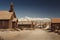 Very old colored vintage photo with abandoned western saloon building in the middle of a desert