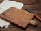 Very old empty wooden rectangular cutting board and knife, top view