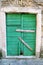 Very old green rustic wood door / Housing insurance. Background, texture and material
