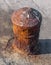 Very old iron bollard on concrete marine dock for boat