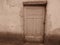 Very old isoleted broken wooden house door in Sepia colour. Abandoned house door.